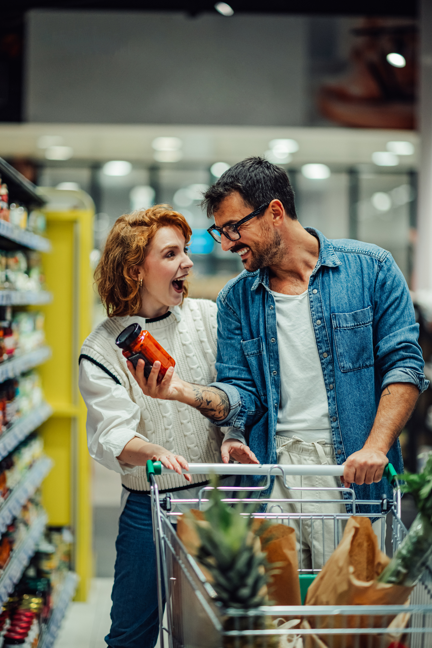 Cheerful couple shopping for groceries at the supermarket